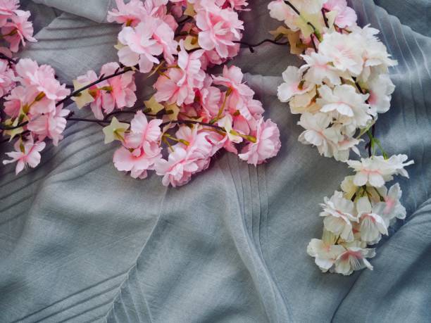 istock cherry blossoms and cotton fabric background 1125793846