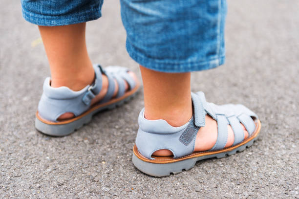 Close up image of new beautiful kids shoes on child's feet stock photo