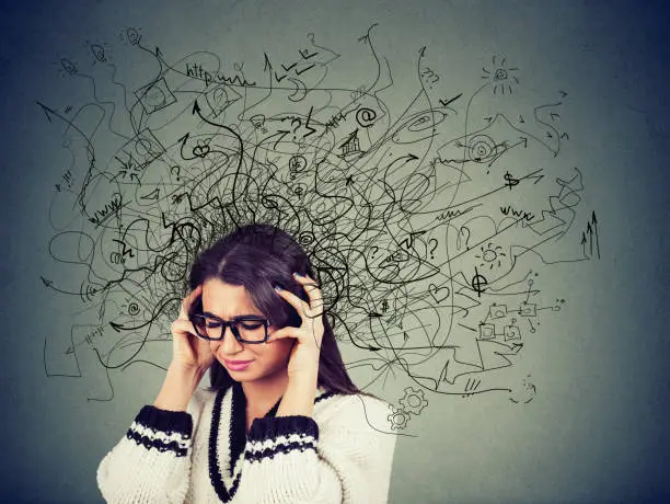 Photo of Thoughtful stressed young woman in glasses with a mess in her head