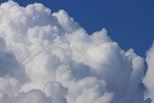 Bright blue sky with white fluffy beautiful cloud formation on sunny day for design background and wallpaper