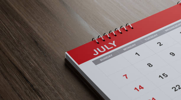 istock Red July 2019 Calendar On  Brown Wood Surface 1125801097
