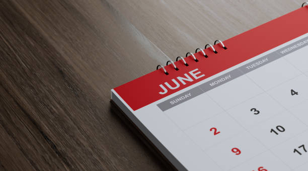 istock Red June 2019 Calendar On  Brown Wood Surface 1125801224
