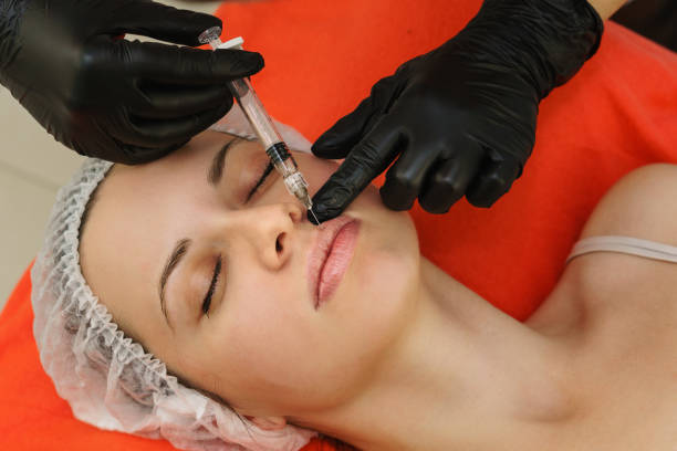 istock Injections and lip augmentation. Medical procedure in spa salon 1125803025