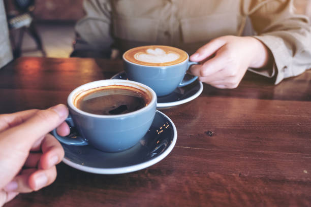 istock a man and a woman clinking blue coffee mugs 1125803113