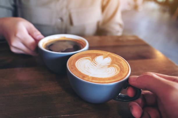 istock a man and a woman clinking blue coffee mugs 1125803114