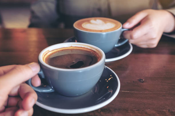 istock a man and a woman clinking blue coffee mugs 1125803133