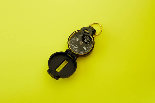 istock Minimal Compass on bright yellow background ,Concept of Travel 1125803219