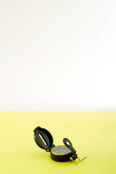 istock Minimal Compass on bright yellow background ,Concept of Travel 1125803238
