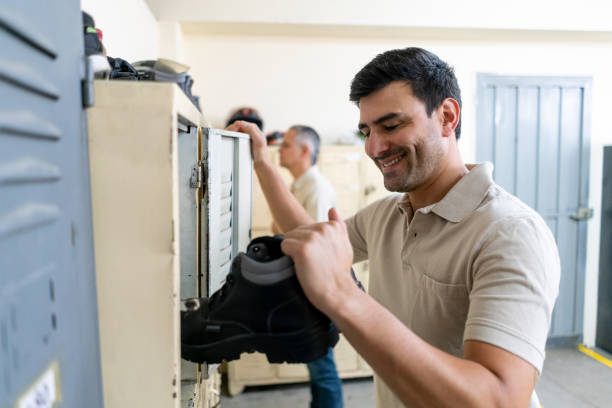 istock Latin american handsome man getting his working boots out of the locker getting ready to work 1125804304
