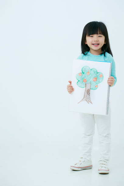istock Korean girl holding apple tree drawing 1125808446