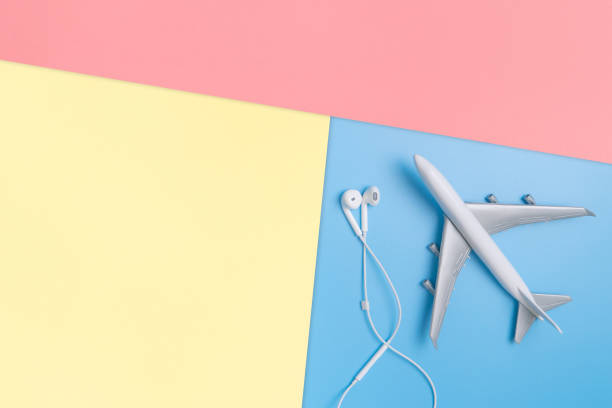 istock plane with earphone on blue copy space for poster and text 1125808659