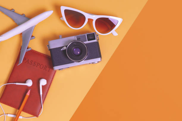 istock travel objects and accessories on orange background with passport camera and plane 1125808668
