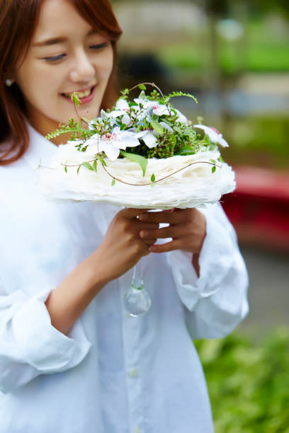 istock Korean woman holding flower bouquet 1125810030