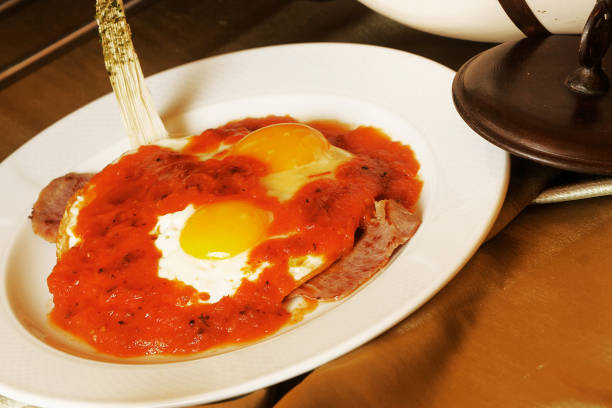 istock Two fried eggs served over beef fillet with red sauce 1125813572