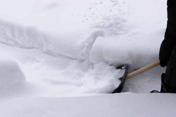 istock Man cleans snow with a shovel in winter 1125816737