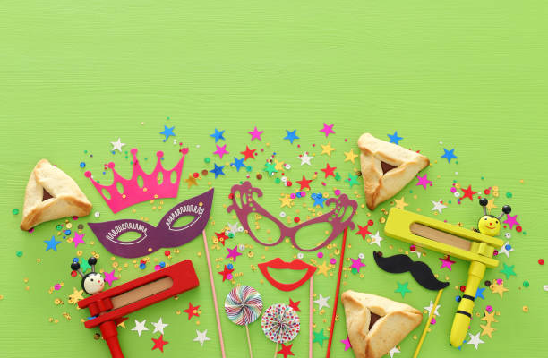 istock Purim celebration concept (jewish carnival holiday) over green wooden background. Top view, Flat lay. 1125820007