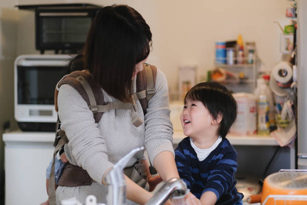 istock Toddler washing hands with mother at kitchen 1125823096