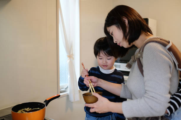 istock Child cooking with mother in kitchen 1125823123