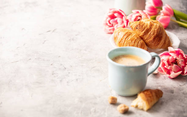 istock Morning coffee, croissants and spring tulips on light grey background 1125823278