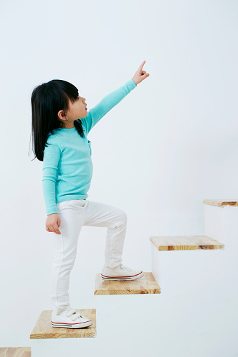 Korean girl climb the stairs and pointing upwards