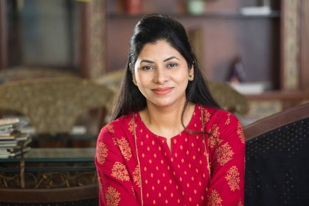 istock Woman sitting on sofa at home 1125824089