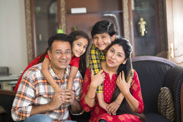 Happy Indian family Happy Indian family sitting on sofa in the living room happy indian young family couple stock pictures, royalty-free photos & images
