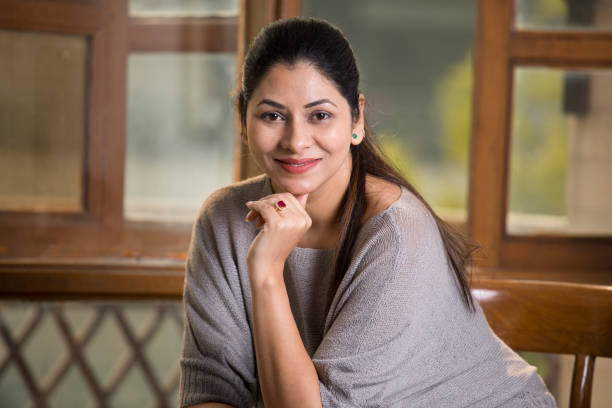 Beautiful young woman sitting at home
