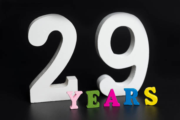 istock Letters and numbers twenty-nine years on a black background. 1125828095