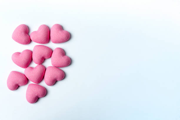 istock Decorative pink hearts on a white background. 1125828336