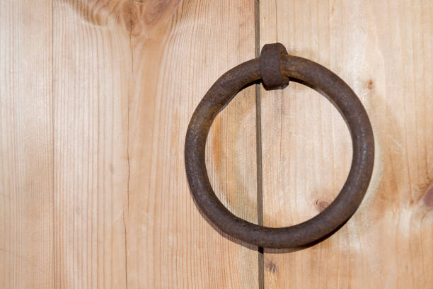 A wooden door with a ring in rural areas.