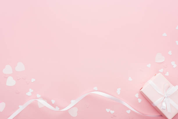 istock background with gift box and paper hearts isolated on pink 1125831147