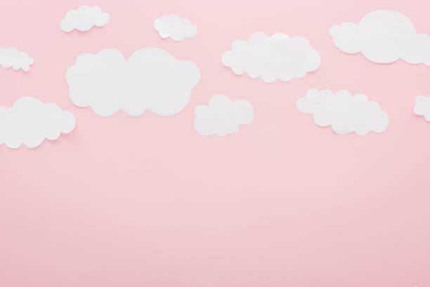 istock top view of white paper clouds isolated on pink with copy space 1125831156