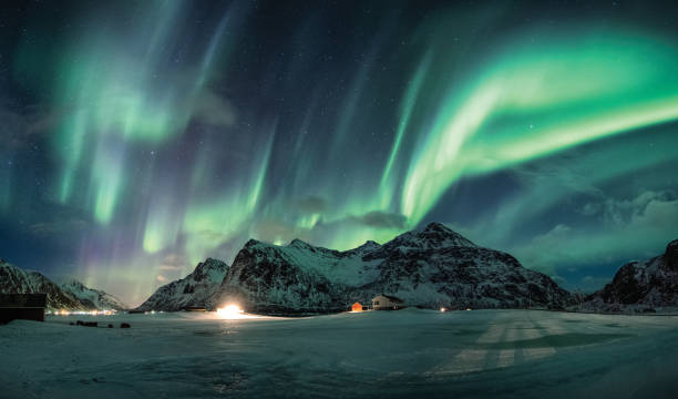 istock Aurora borealis or Northern lights over snow mountain on coastline 1125831206