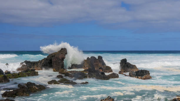 istock a wave crashes against the rocks at ho'okipa beach on maui 1125833368