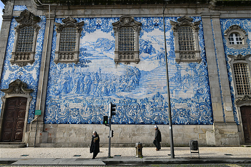 External wall of the Carmo and Carmelites church in Porto, adorned by white tiles (Azulejos) painted in blue.