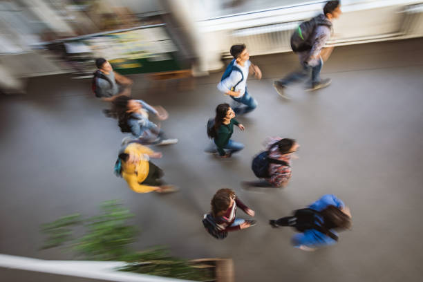 istock Above view of large group of students running in blurred motion. 1125837401