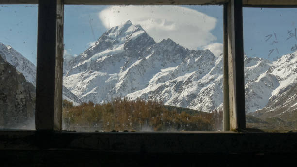 istock mt cook looking through the windows of stocking stream shelter 1125837488