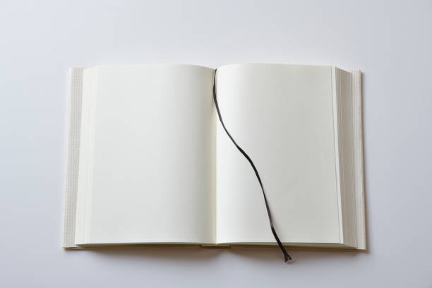 Blank craft paper cover book with lace bookmark lying on white background