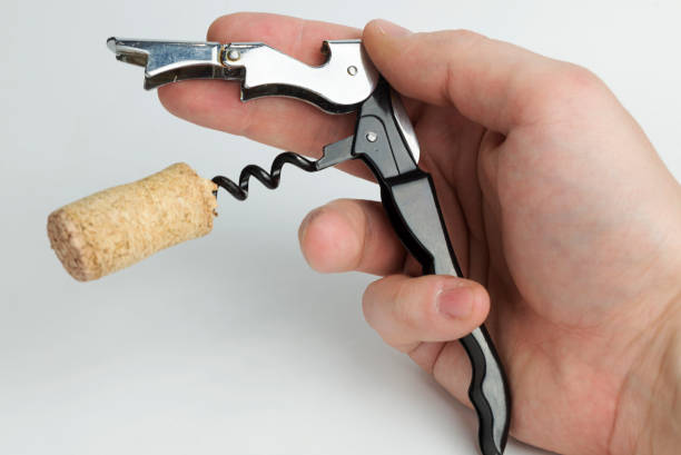 istock The hand holding the corkscrew on white background for wine bottles. 1125838859