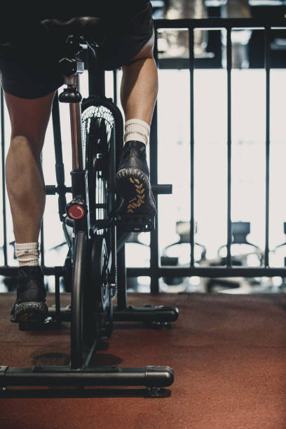 istock Man using exercise bike at the gym 1125839157