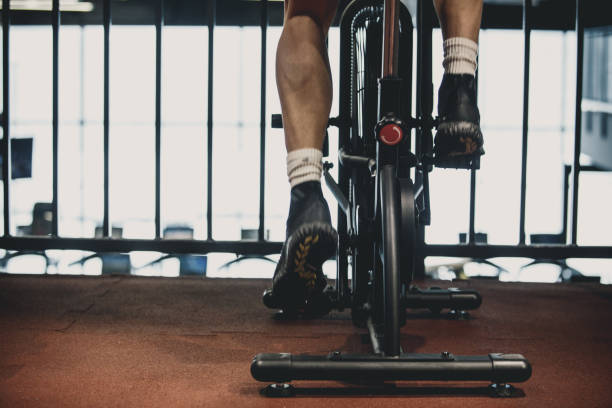 istock Man using exercise bike at the gym 1125839159
