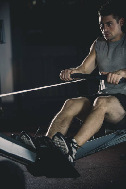 istock Man exercising on rowing machine at the gym 1125840242