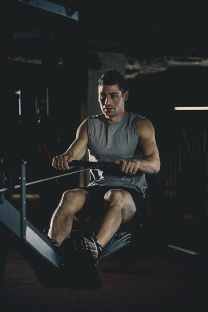 istock Man exercising on rowing machine at the gym 1125840248