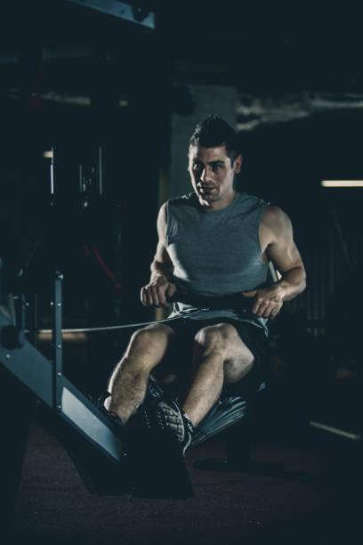 istock Man exercising on rowing machine at the gym 1125840253