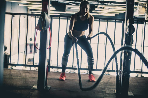 istock Woman training with battle ropes 1125840759