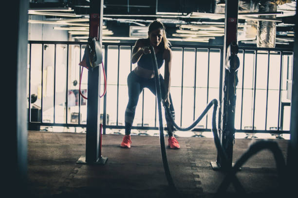 istock Woman training with battle ropes 1125840761