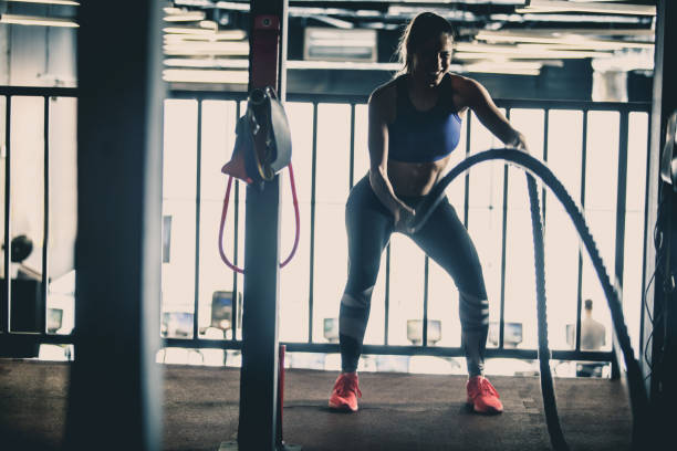 istock Woman enjoying battle rope workout 1125840768