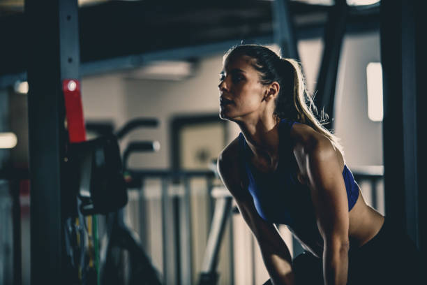 istock Young woman exercising at the gym 1125840841
