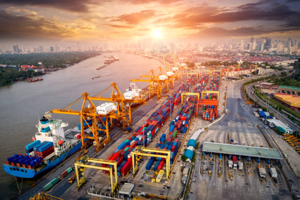 istock Logistics and transportation of Container Cargo ship and Cargo plane with working crane bridge in shipyard at sunrise, logistic import export and transport industry background 1125841806