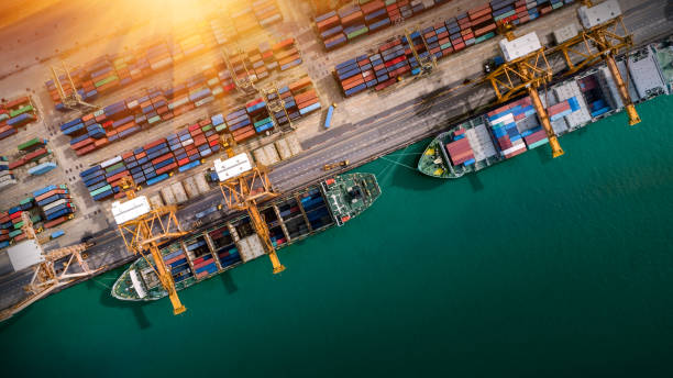 istock Logistics and transportation of Container Cargo ship and Cargo plane with working crane bridge in shipyard at sunrise, logistic import export and transport industry background 1125841834
